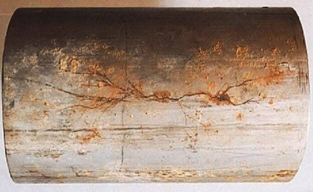 Original photograph of branching stress corrosion cracking on a cylindrical metal component